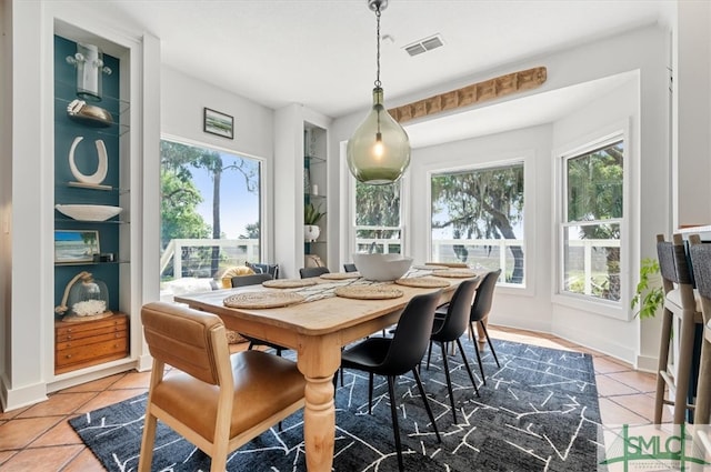 dining room featuring tile flooring and a healthy amount of sunlight