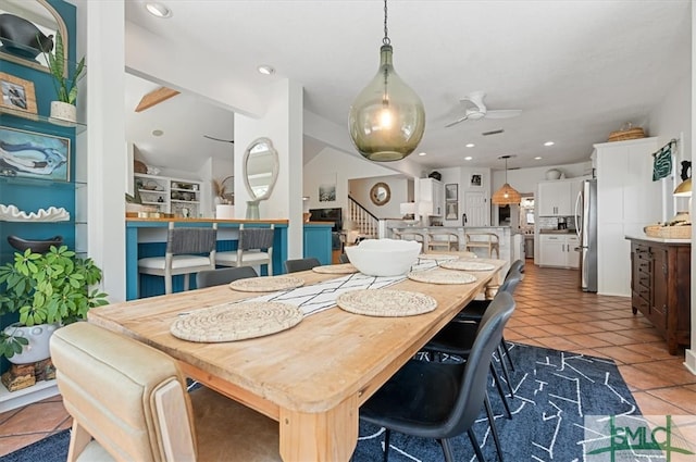 dining area featuring ceiling fan and light tile floors