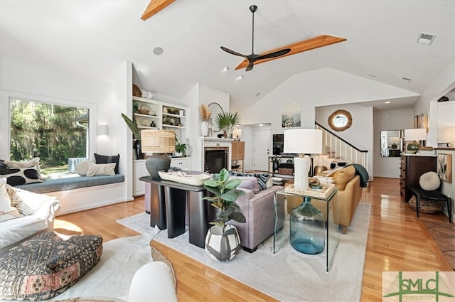 living room featuring high vaulted ceiling, light hardwood / wood-style floors, and ceiling fan