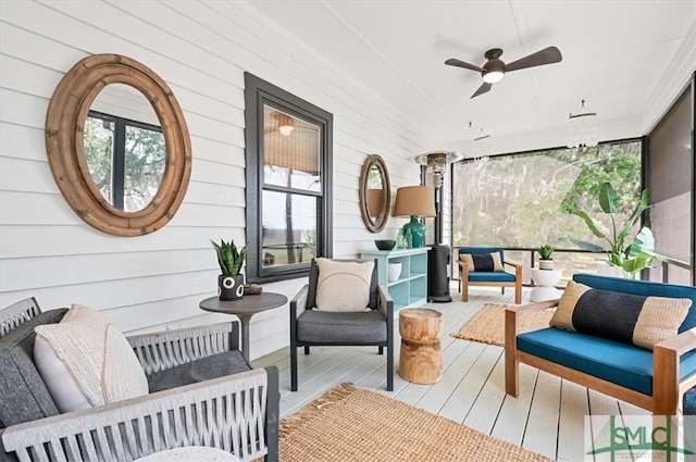 sunroom / solarium featuring ceiling fan