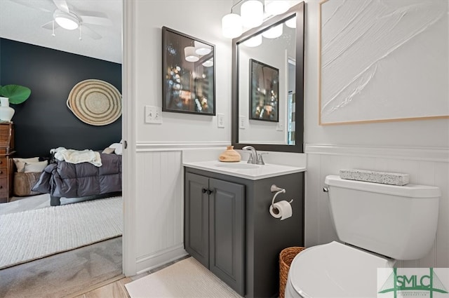 bathroom with ceiling fan, vanity, and toilet