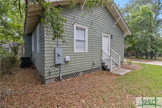 view of side of home featuring central AC