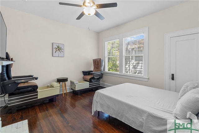 bedroom with ceiling fan and dark hardwood / wood-style flooring