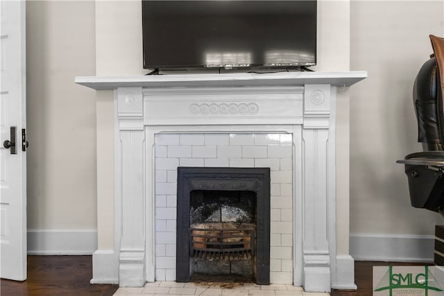 details featuring hardwood / wood-style floors, vanity, and a fireplace