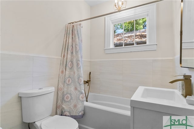 full bathroom featuring vanity, shower / bath combination with curtain, toilet, and tile walls