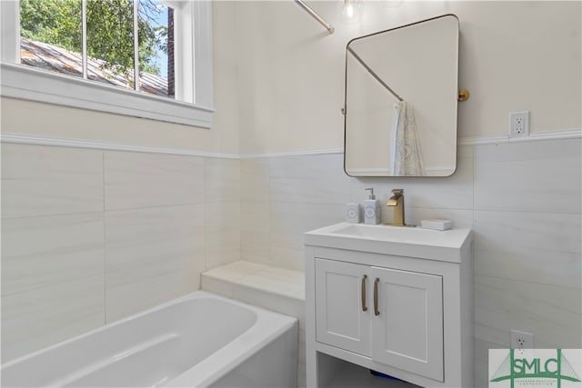 bathroom featuring vanity and tile walls