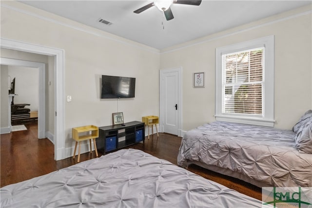 bedroom with ceiling fan, dark wood-type flooring, and ornamental molding