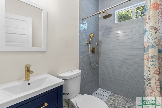 bathroom featuring a shower with curtain, vanity, and toilet