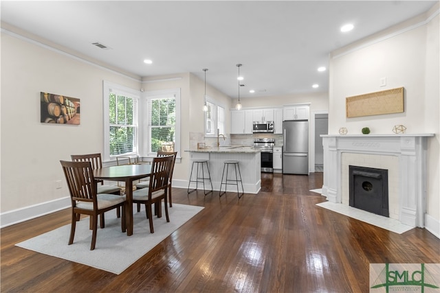 dining area featuring dark hardwood / wood-style flooring and sink