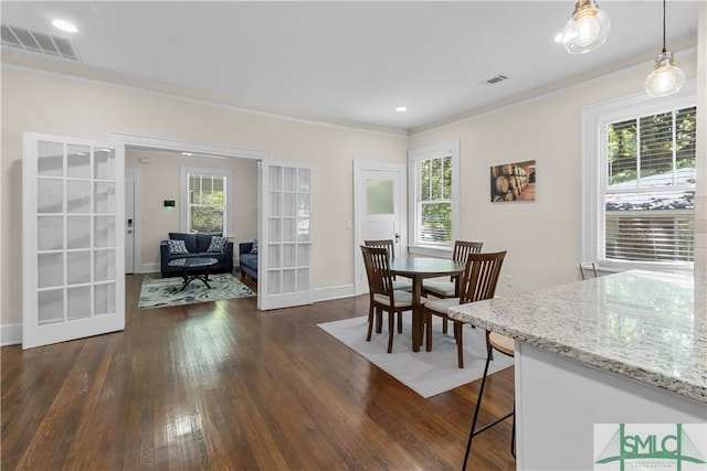 dining room featuring french doors, dark wood-type flooring, and crown molding