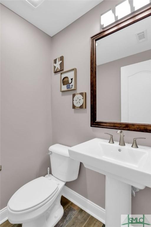 bathroom featuring sink, hardwood / wood-style flooring, and toilet