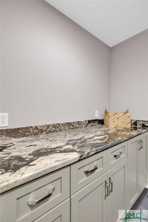 kitchen with stone countertops and white cabinets