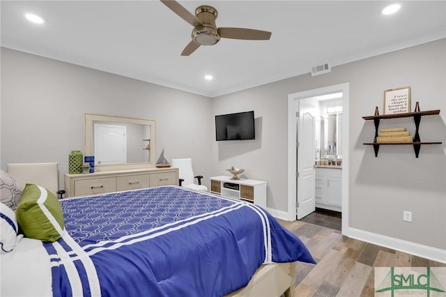 bedroom with ensuite bath, light hardwood / wood-style floors, and ceiling fan