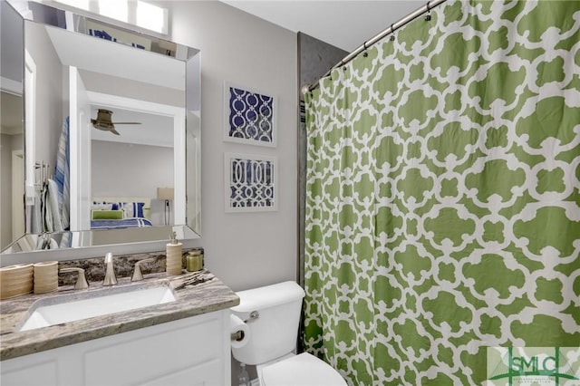 bathroom featuring ceiling fan, vanity, and toilet