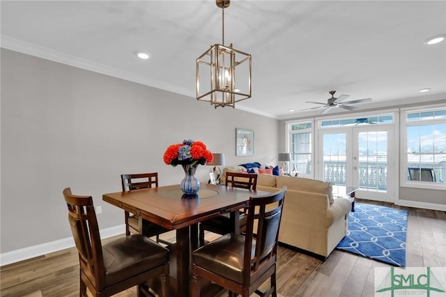 dining space featuring ornamental molding, plenty of natural light, and wood-type flooring