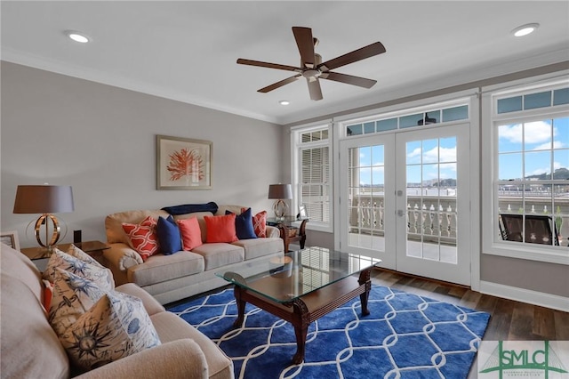 living room with crown molding, ceiling fan, dark hardwood / wood-style flooring, and french doors