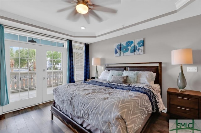 bedroom with dark hardwood / wood-style flooring, access to exterior, a raised ceiling, crown molding, and french doors