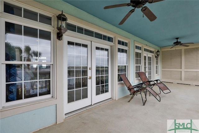 unfurnished sunroom with ceiling fan and french doors