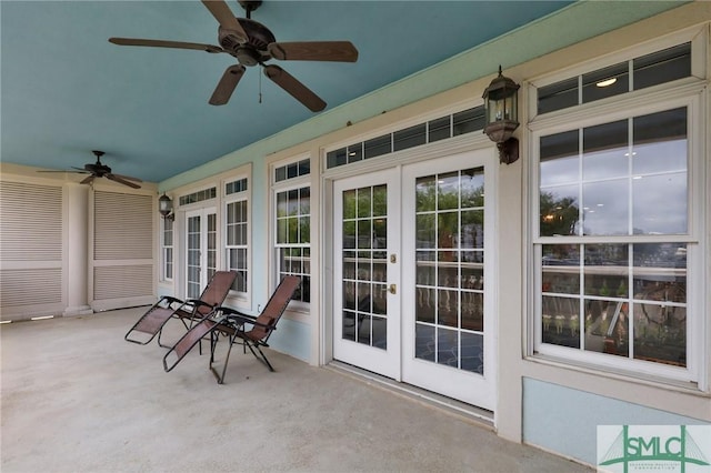 unfurnished sunroom with ceiling fan and french doors