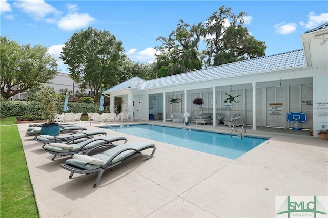 view of swimming pool with a patio area