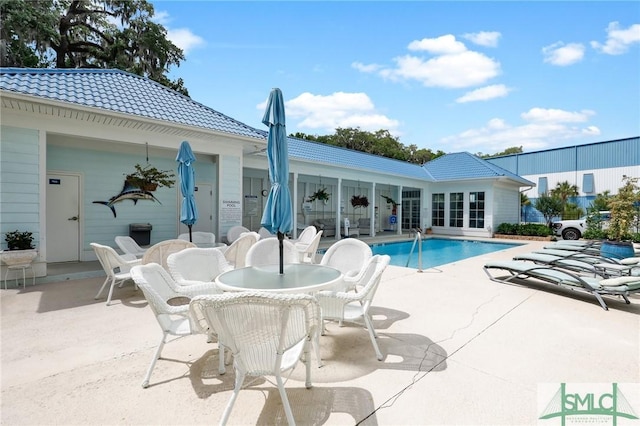 view of swimming pool with a patio