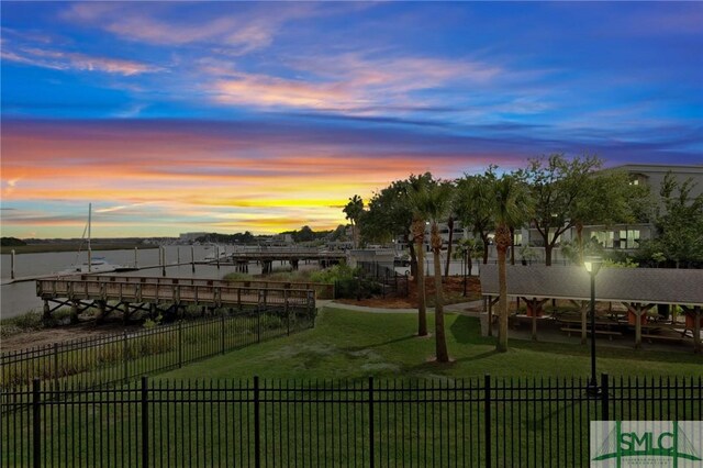 view of property's community with a yard and a water view