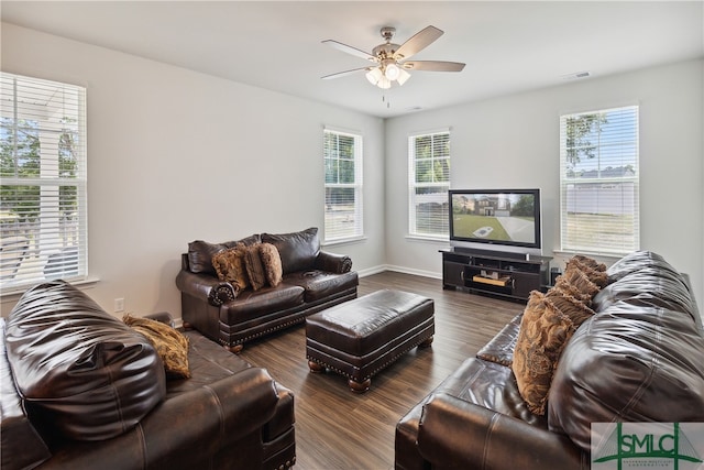 living room featuring a wealth of natural light, ceiling fan, and dark hardwood / wood-style floors