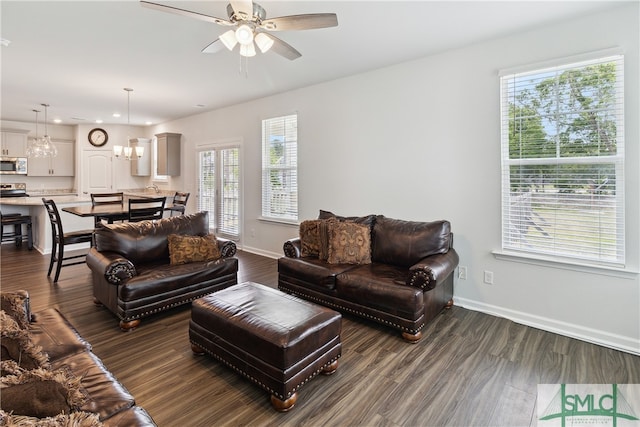 living room featuring ceiling fan and dark hardwood / wood-style floors