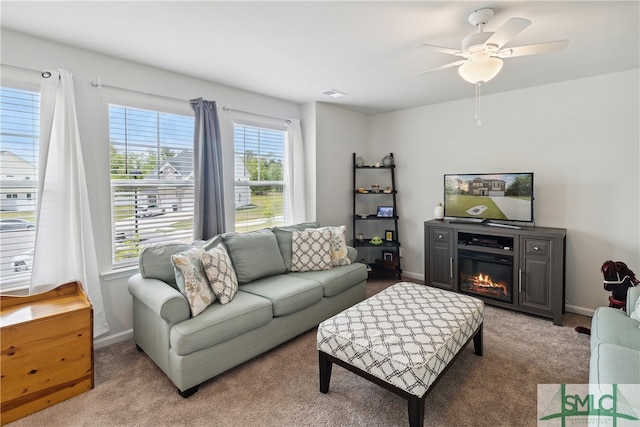 carpeted living room featuring ceiling fan