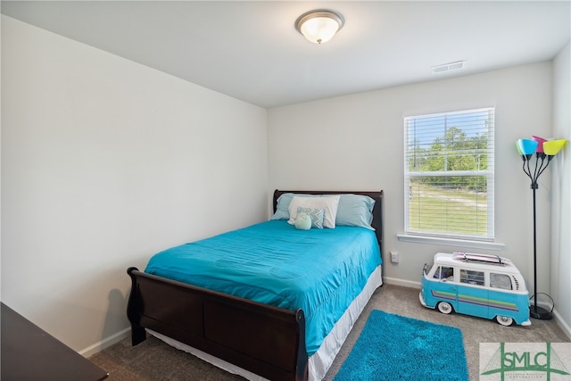 bedroom with multiple windows and carpet flooring