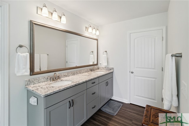 bathroom featuring dual sinks, wood-type flooring, and oversized vanity