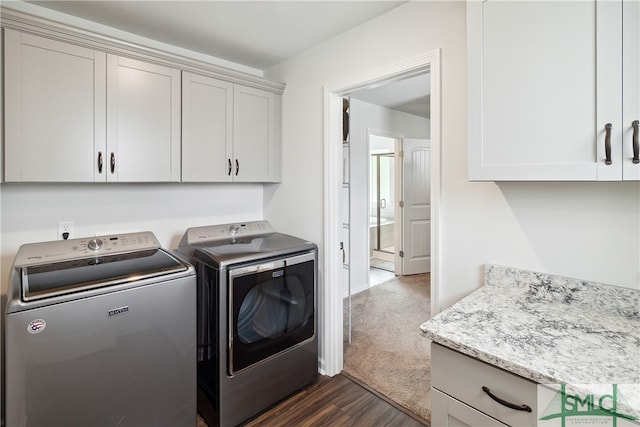 laundry room with cabinets, separate washer and dryer, and dark hardwood / wood-style floors