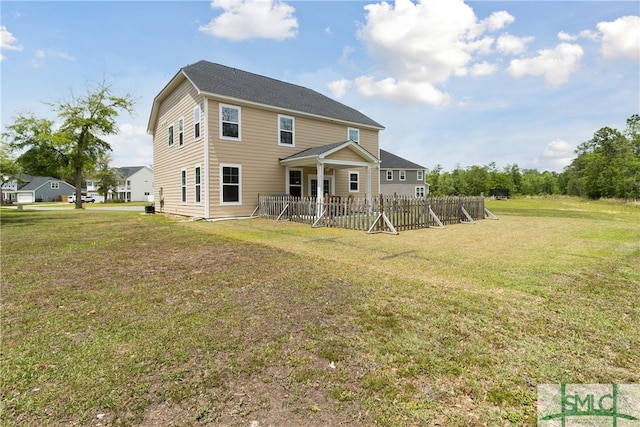 rear view of property featuring a yard