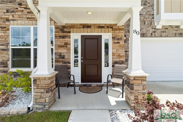 property entrance with a garage and a porch