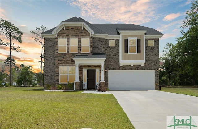 view of front of home with a yard and a garage