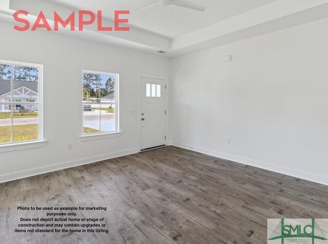 empty room featuring wood-type flooring and ceiling fan