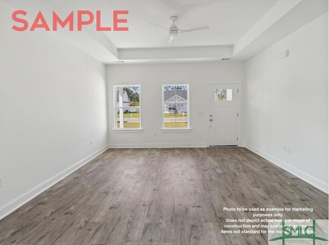 empty room with hardwood / wood-style floors and ceiling fan