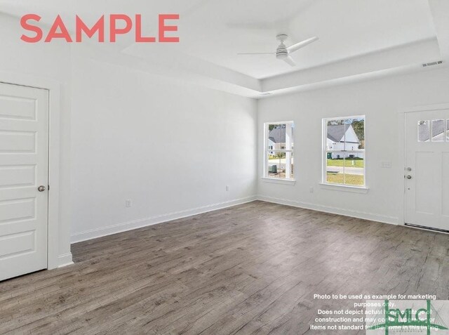 empty room with ceiling fan and hardwood / wood-style flooring