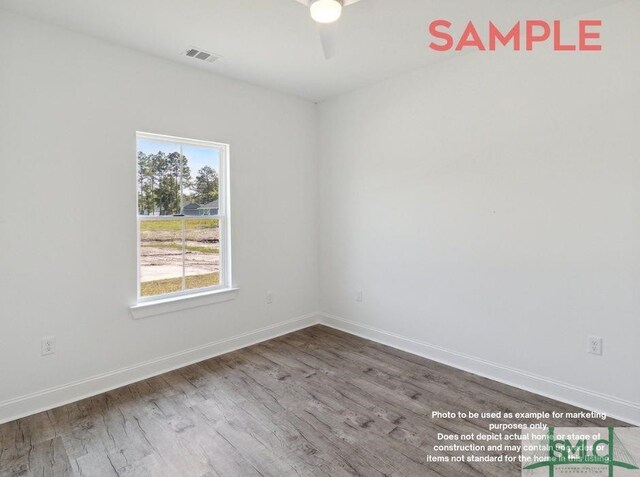 empty room with hardwood / wood-style flooring