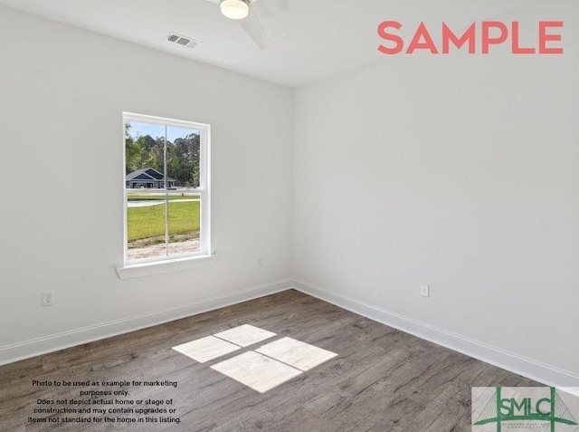 empty room featuring ceiling fan and hardwood / wood-style floors