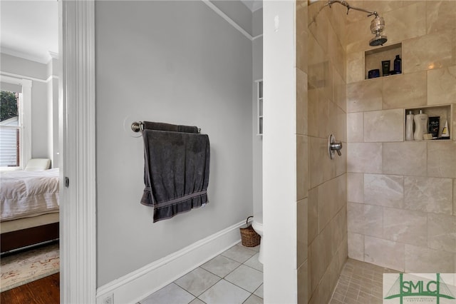 bathroom featuring crown molding, a tile shower, and tile flooring