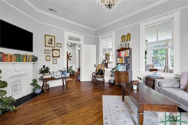 living room featuring crown molding, dark hardwood / wood-style flooring, and a notable chandelier