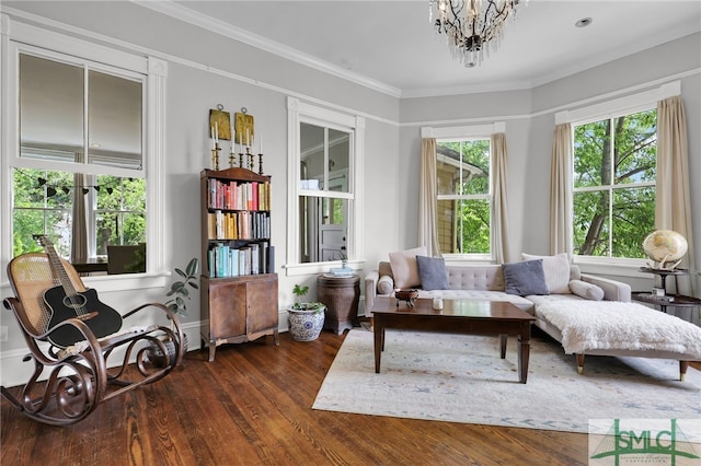 sitting room with dark hardwood / wood-style flooring, a notable chandelier, and ornamental molding