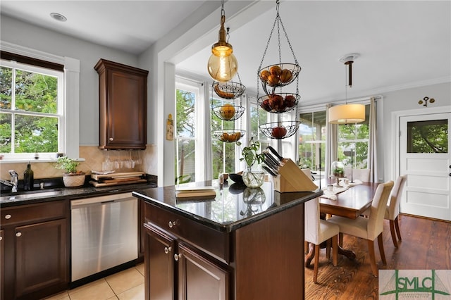 kitchen featuring dark stone countertops, sink, tasteful backsplash, and dishwasher