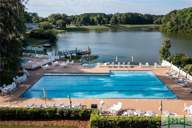 view of swimming pool with a patio and a water view