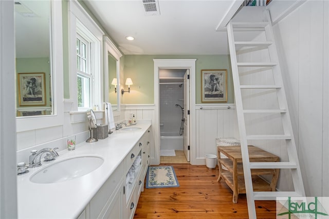 bathroom featuring hardwood / wood-style flooring, double sink, and large vanity