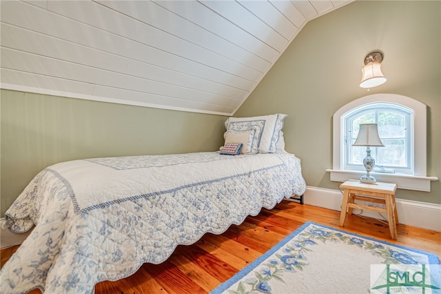 bedroom featuring wood-type flooring and lofted ceiling