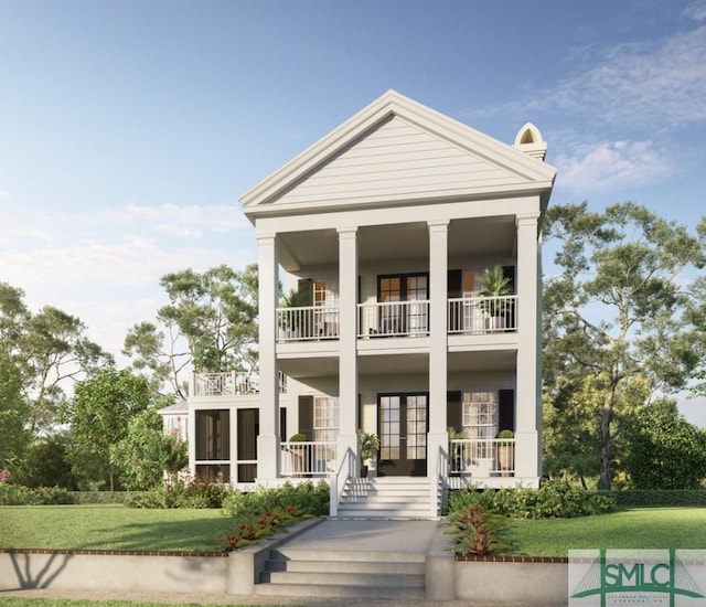 view of front facade with a balcony and a front lawn