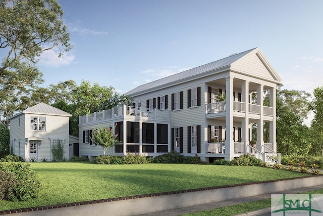 view of front of house with a balcony and a front yard