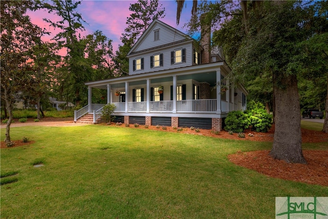 farmhouse inspired home featuring a lawn and covered porch